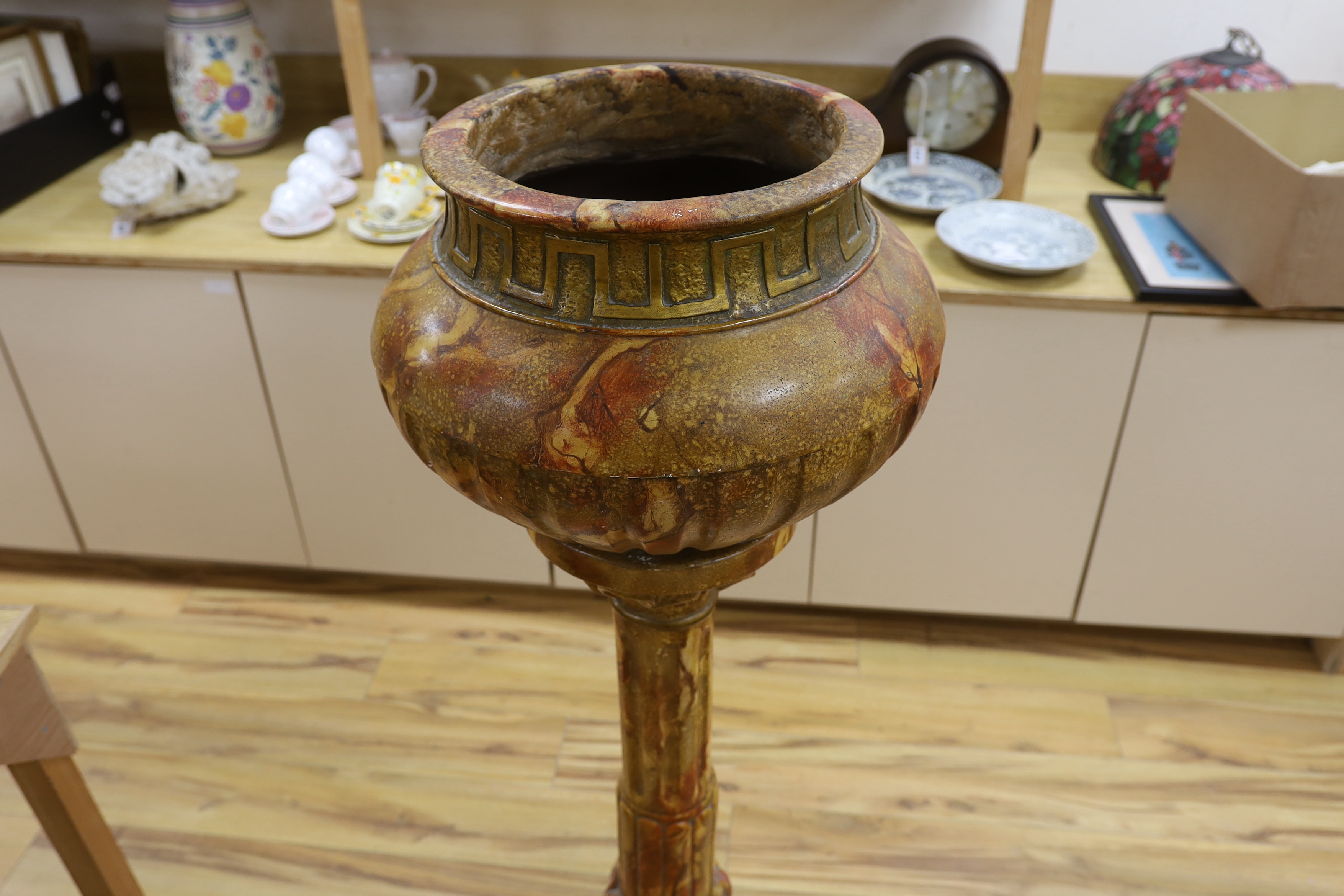 A large faux marble pottery jardiniere on stand, 126cm total height